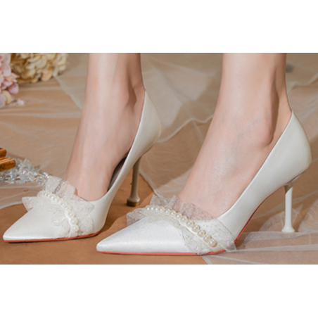 Classy white pumps with pretty pearl pattern on the front for wedding